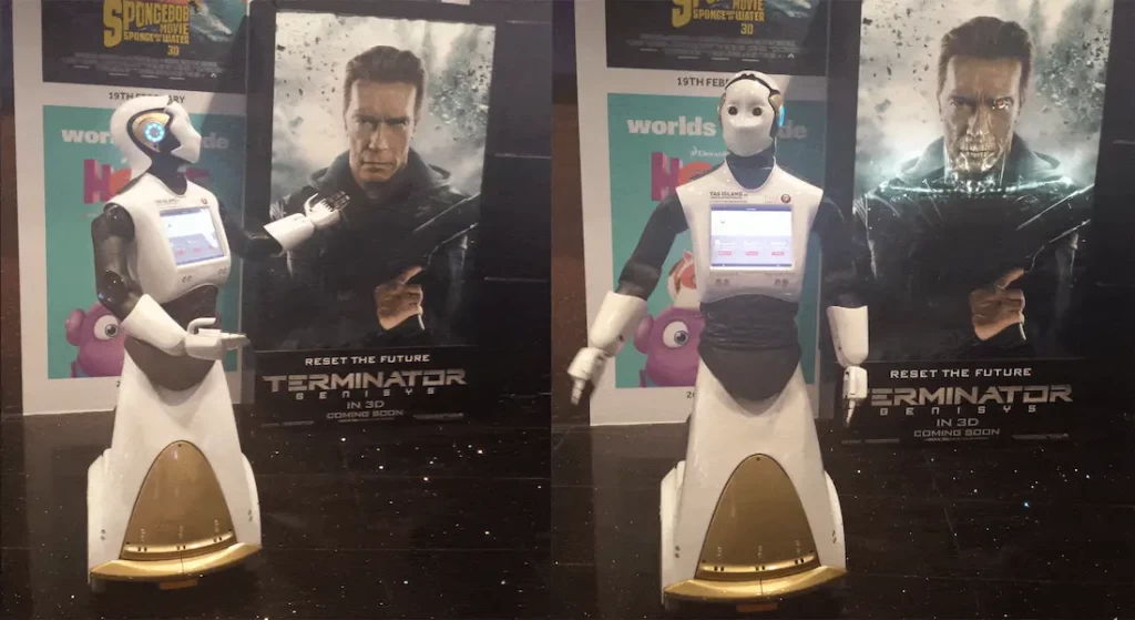 The humanoid robot REEM-C in front of a Terminator movie poster