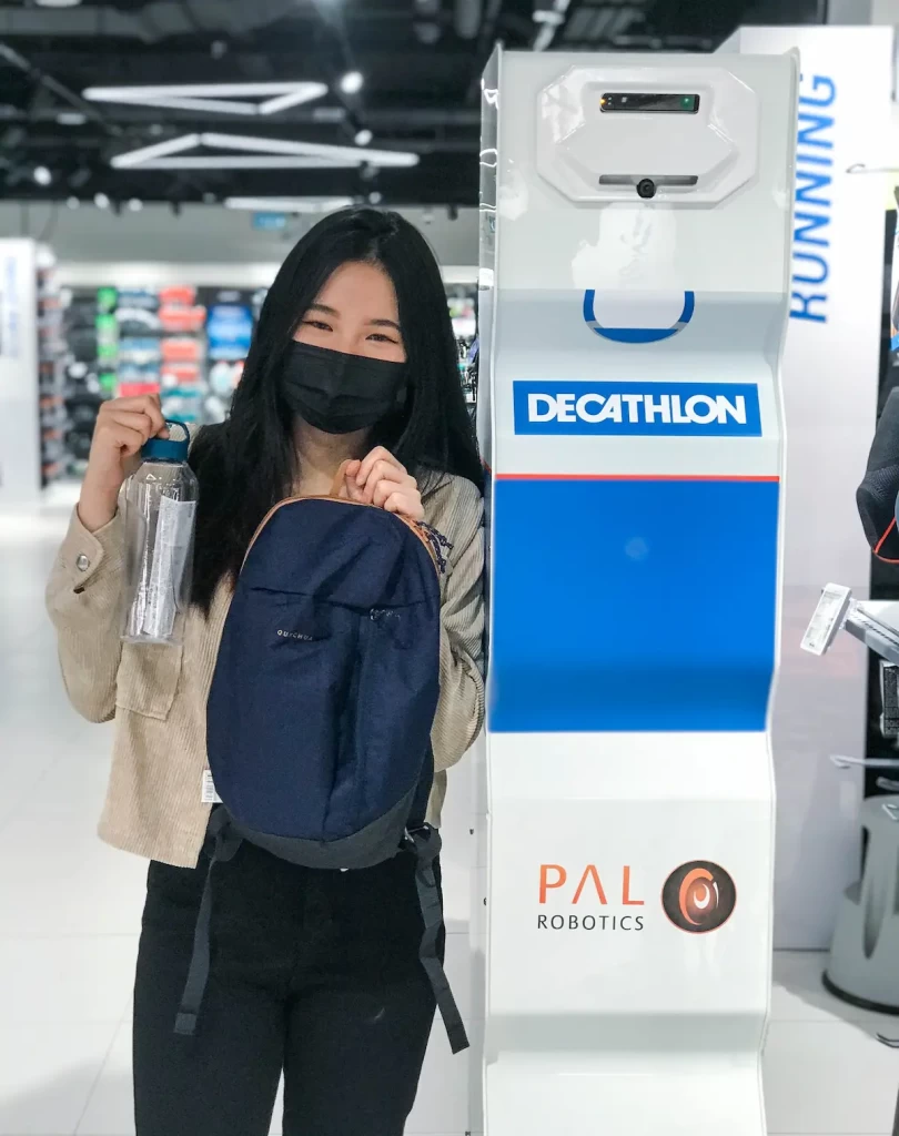Young woman in front of StockBot at Decathlon