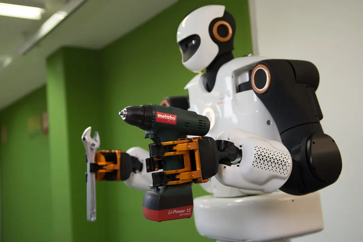 The biped humanoid research robot TALOS holding a drill and a wrench