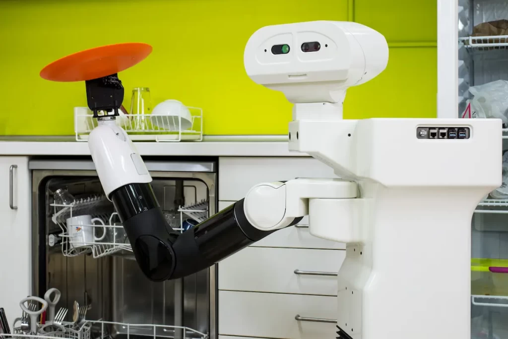 The mobile manipulator TIAGo robot emptying a dishwasher