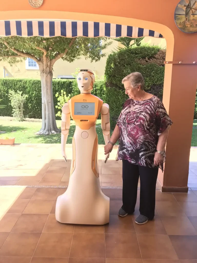 The social robot ARI helps an elderly woman during Project SHAPES