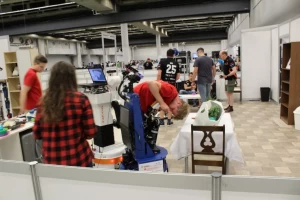 Homer Team sets up the mobile manipulator TIAGo robot during the RoboCup challenge